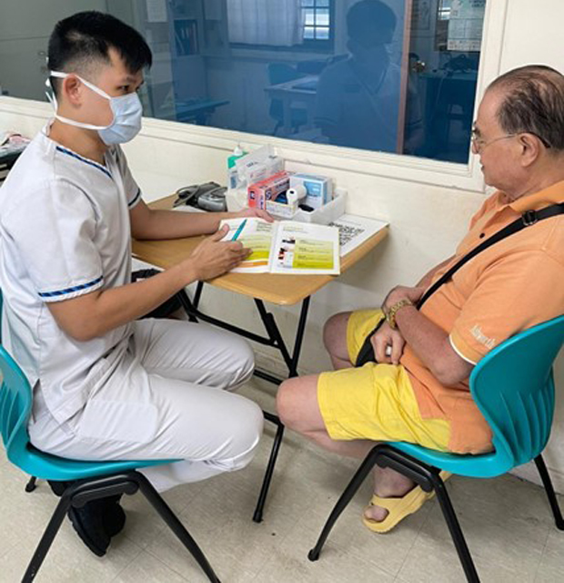  ​Vincent going through Advance Care Planning with a resident, Mr Chor. 