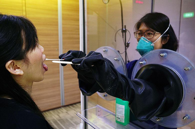  ​Throat swabs being done with SG Safe (above), a transparent booth system  PHOTO SGH