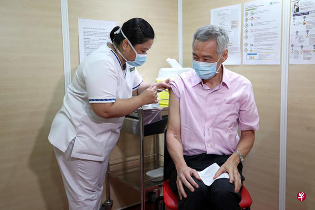  ​Prime Minister Lee Hsien Loong receiving his second dose of the Covid-19 vaccine at the Singapore General Hospital yesterday. It was administered by senior staff nurse Fatimah Mohd Shah, who had given him the first dose.PHOTO MCI