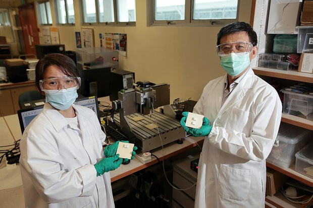  ​Associate Professor Lu Wen Feng (right), director of the National University of Singapore's Centre for Additive Manufacturing (AM.NUS), with researcher and principal engineer Chang Soon Yee. They are holding 3D-printed objects made from coral powder. ST PHOTO GIN TAY