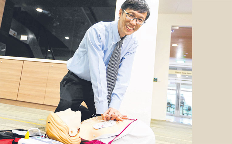 showing how to use an automated external defibrillator yesterday. He says Singapore still has some way to go in CPR training.